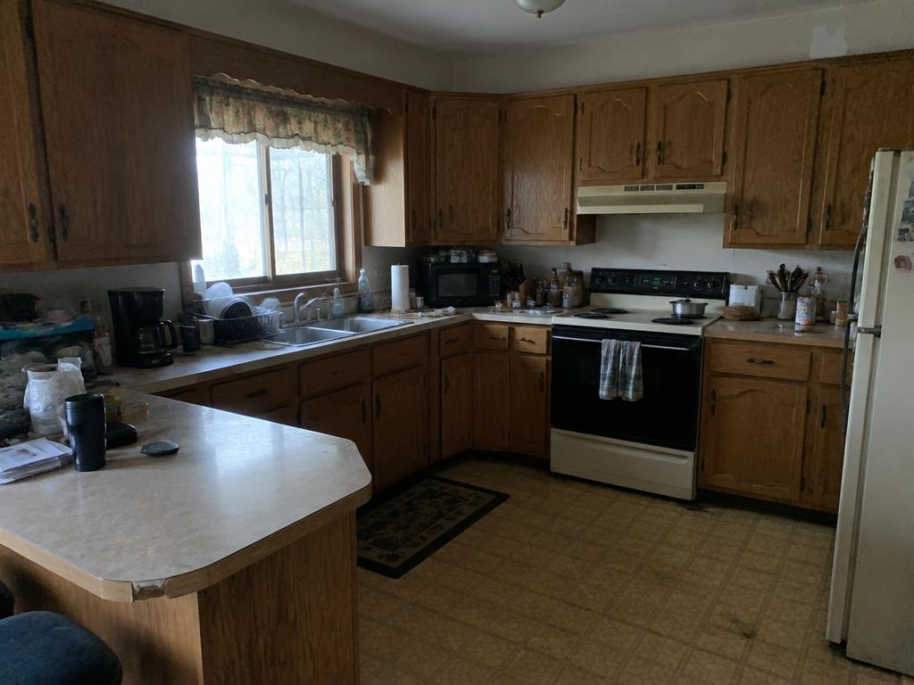 Before: Worn oak cabinets and dated laminate countertop