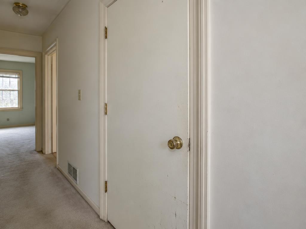 Before: Scuffed slab door and worn brass hardware